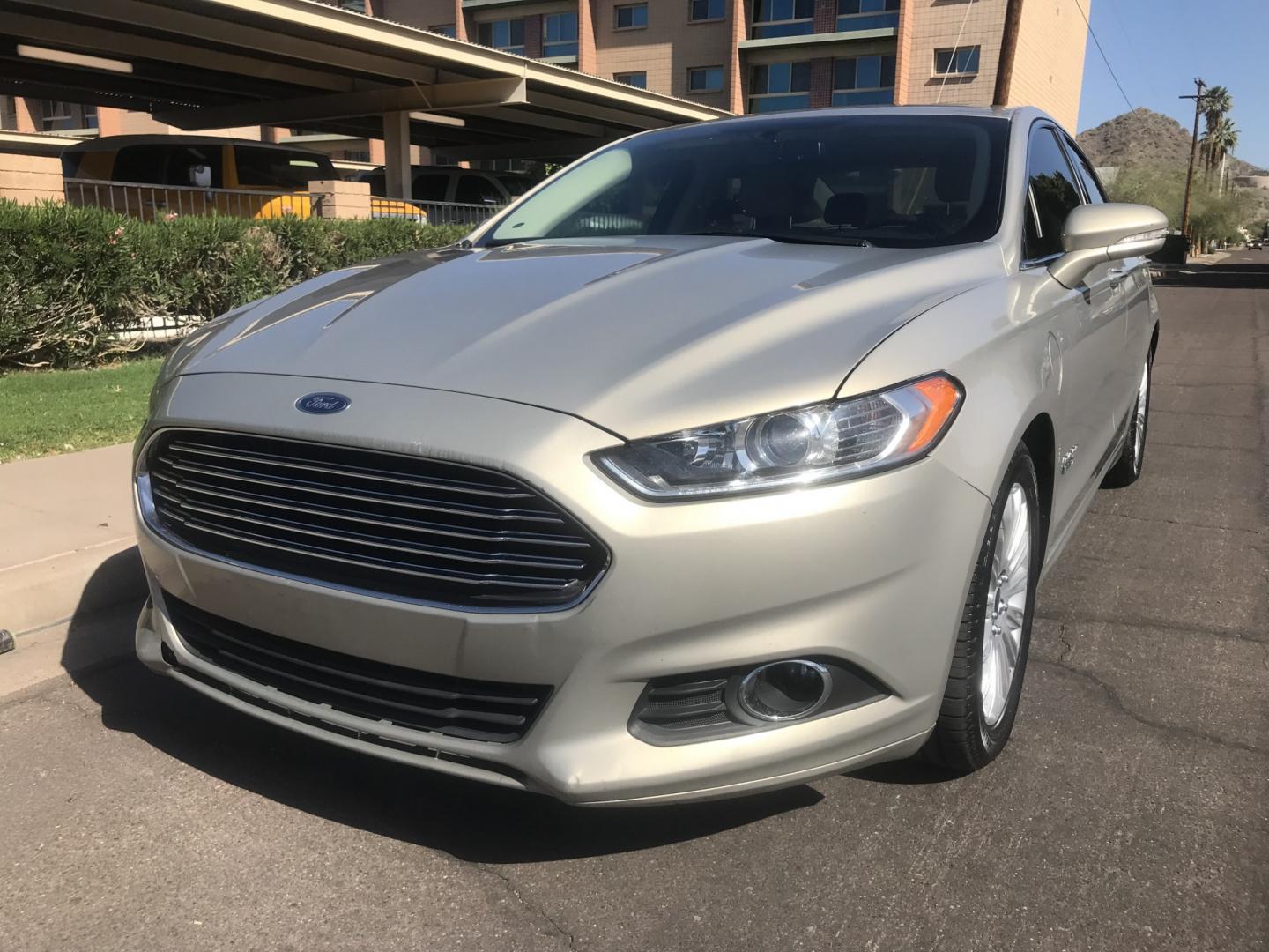 2015 gold /tan Ford Fusion Energi SE (3FA6P0PU9FR) with an 2.0L L4 DOHC 16V HYBRID engine, CVT transmission, located at 323 E Dunlap Ave., Phoenix, AZ, 85020, (602) 331-9000, 33.567677, -112.069000 - 2015 Ford Fusion HYBRID ,........GREAT condition, A Real Must See!!.... LOW 120k miles, Automatic, Power Options, Premium Sound CD, Ice cold ac, Clean gold exterior with beige seats, clean Arizona title, Runs and Drives Excellent. Very clean inside and out, SUPER ECONOMICAL Sedan, Any questions Call- Photo#0